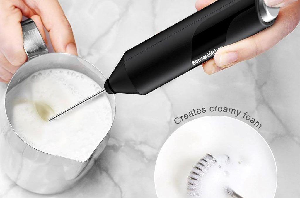 Bonsenkitchen handheld milk frother with stainless steel whisk, shown on kitchen counter beside a latte