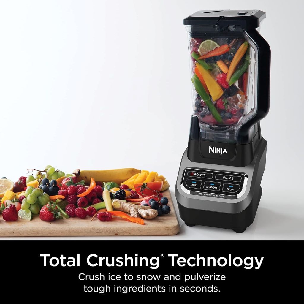 Close-up of Nutribullet 600W blender in use, blending fresh fruits into a smoothie in the 24oz cup