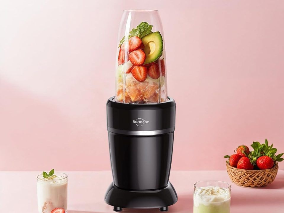 A powerful, black Sangcon 1000W blender with a large glass pitcher sits on a kitchen counter. The blender base has a control panel with various settings, and the lid is secured on top. The scene suggests the blender is ready for making smoothies or other blended drinks.