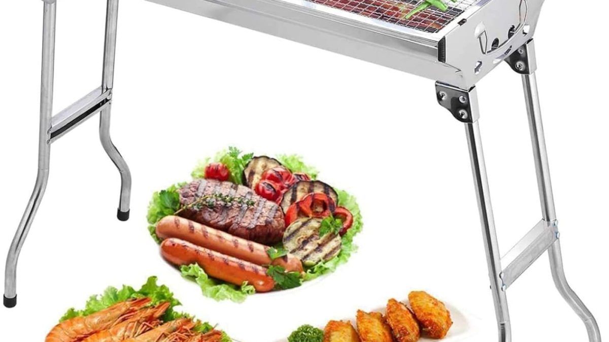 Grill loaded with burgers and skewers on Uten portable charcoal BBQ, perfect for backyard gatherings.