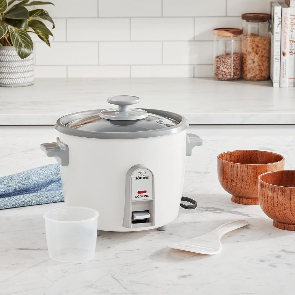 White Zojirushi 3-Cup Rice Cooker and Steamer with accessories