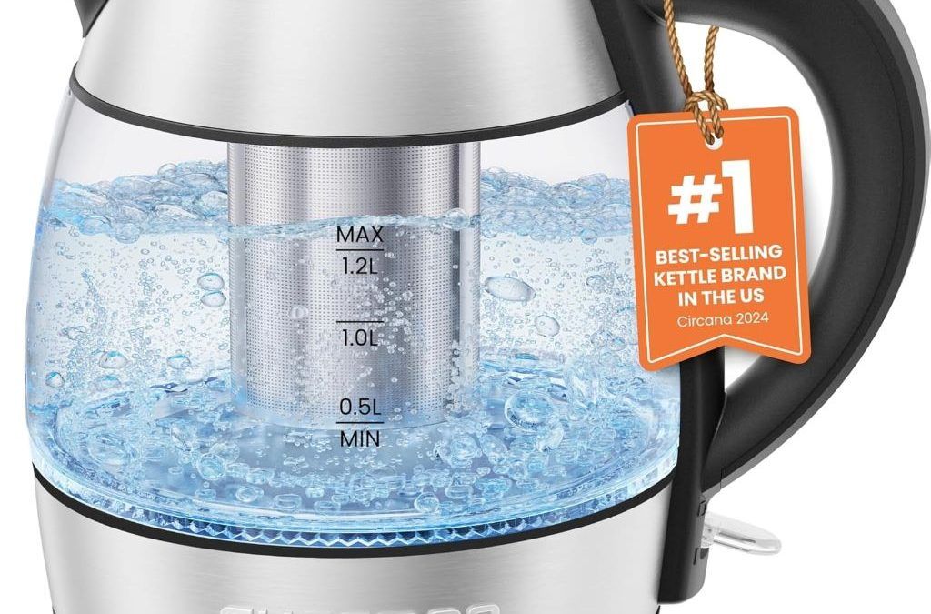 CHEFMAN 1.2L electric glass kettle with stainless steel infuser and LED light on kitchen counter