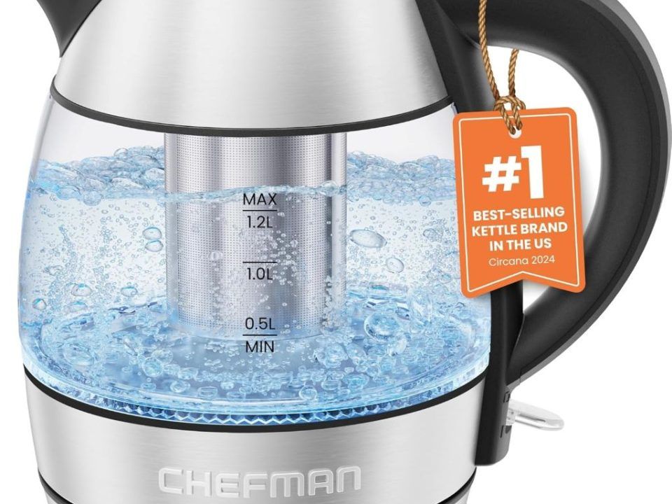 CHEFMAN 1.2L electric glass kettle with stainless steel infuser and LED light on kitchen counter