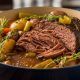 Tender slow-cooked beef chuck roast in Dutch oven with vegetables and rich brown gravy
