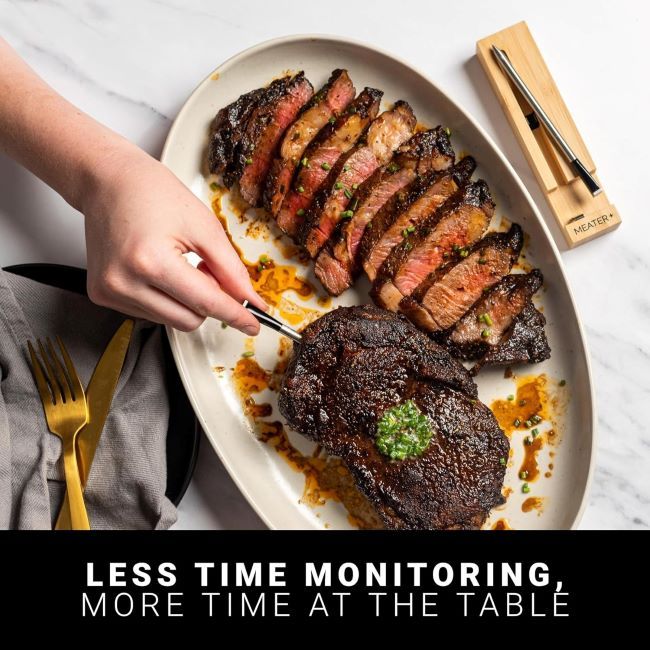 Digital Bluetooth meat thermometer MEATER Plus showing steak and chicken cooking perfectly