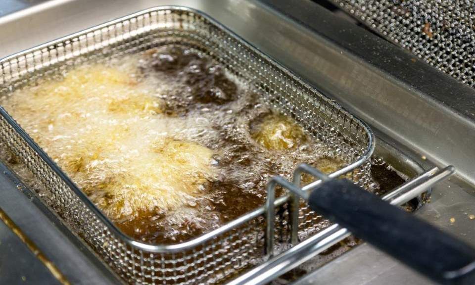 Deep fryer with built in oil filtration system in modern kitchen
