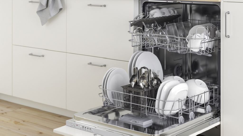 Stainless steel dishwasher opening with clean plates and cups after wash.