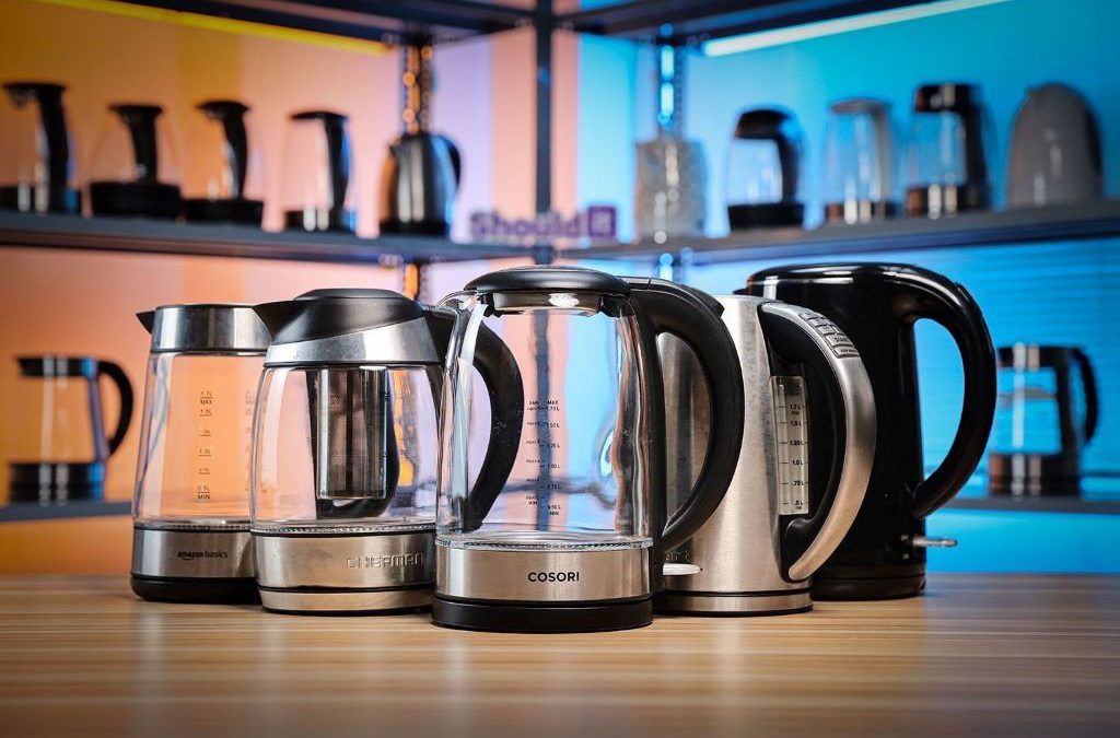Person comparing electric kettles for fast and safe boiling in a modern kitchen
