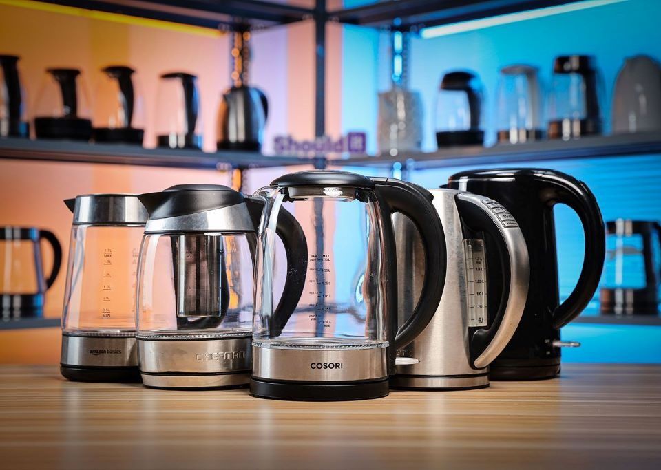 Person comparing electric kettles for fast and safe boiling in a modern kitchen