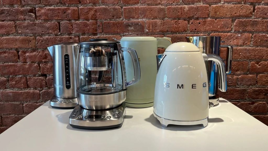 Stainless steel electric kettle boiling water quickly on a kitchen countertop