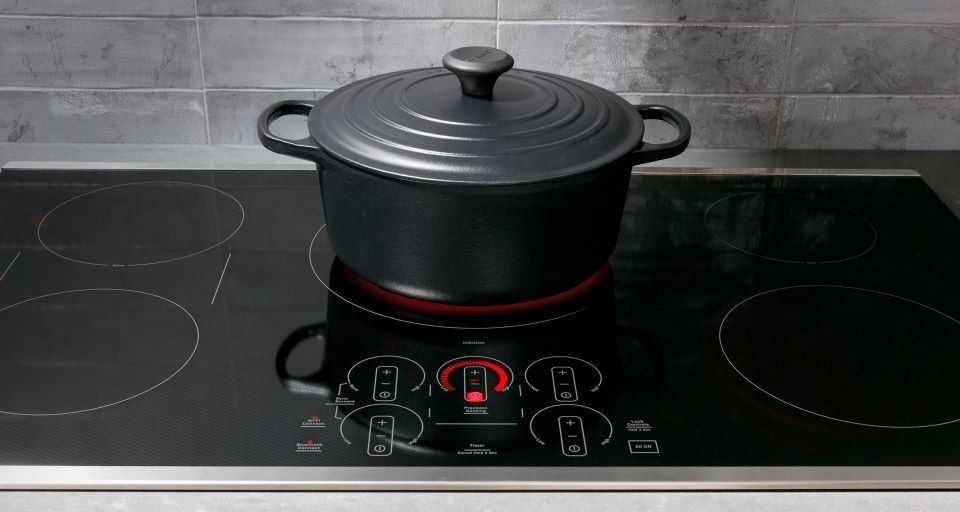 Modern induction cooktop heating pan quickly in a stylish kitchen.
