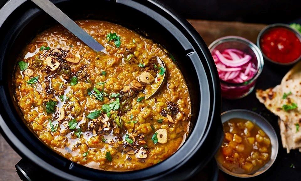 Slow cooker preparing a hearty meal with vegetables and meat for easy home cooking