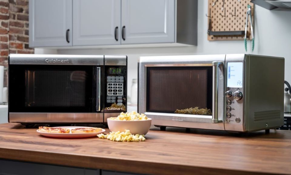 Modern microwave oven placed on kitchen counter with digital control panel.