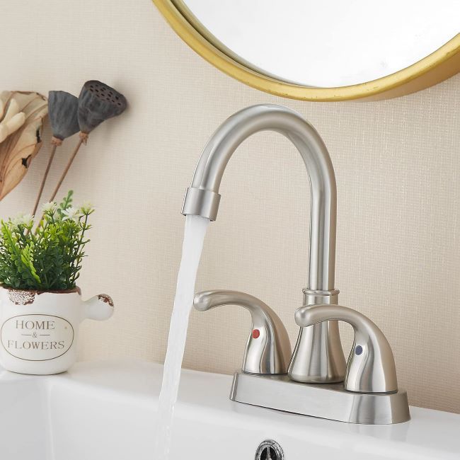 Fransiton bathroom sink faucet with dual handles, brushed nickel finish, and included drain accessories