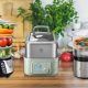 Electric food steamer cooking vegetables and fish for a healthy meal in a kitchen