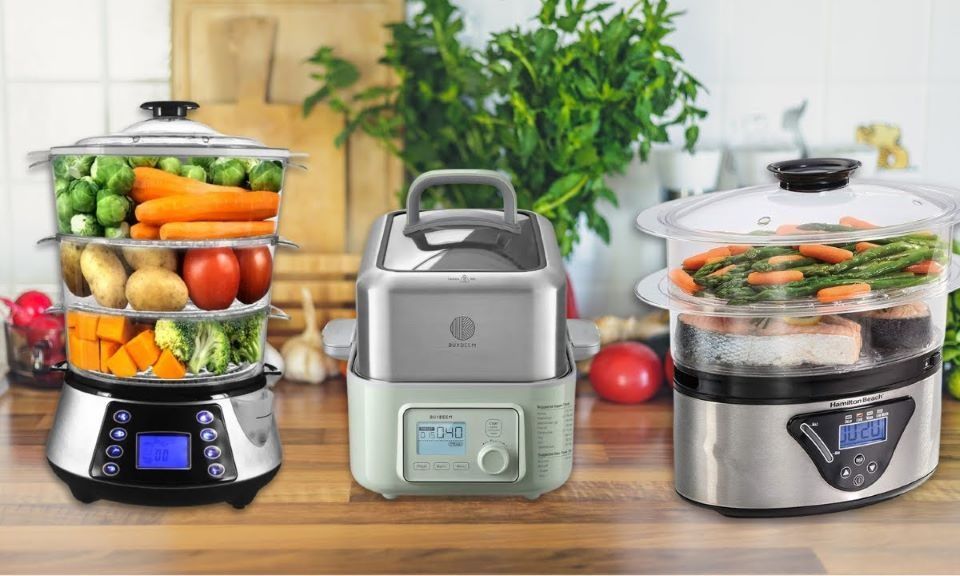 Electric food steamer cooking vegetables and fish for a healthy meal in a kitchen