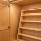 Organized kitchen pantry cabinets with labeled storage containers