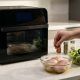 Smart air fryer oven cooking a full meal with chicken and vegetables