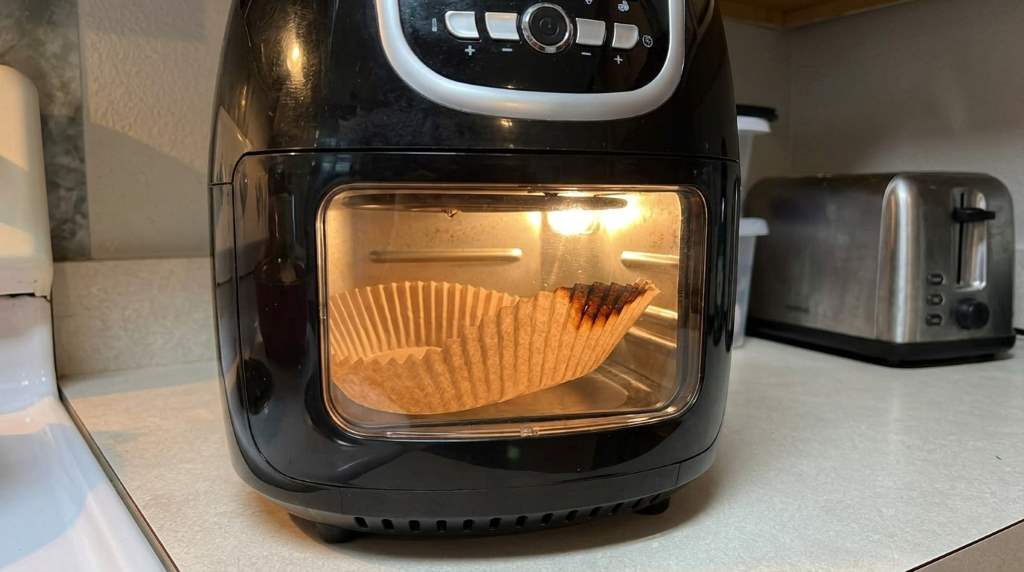 Air fryer liner burning caused by exposed parchment edge