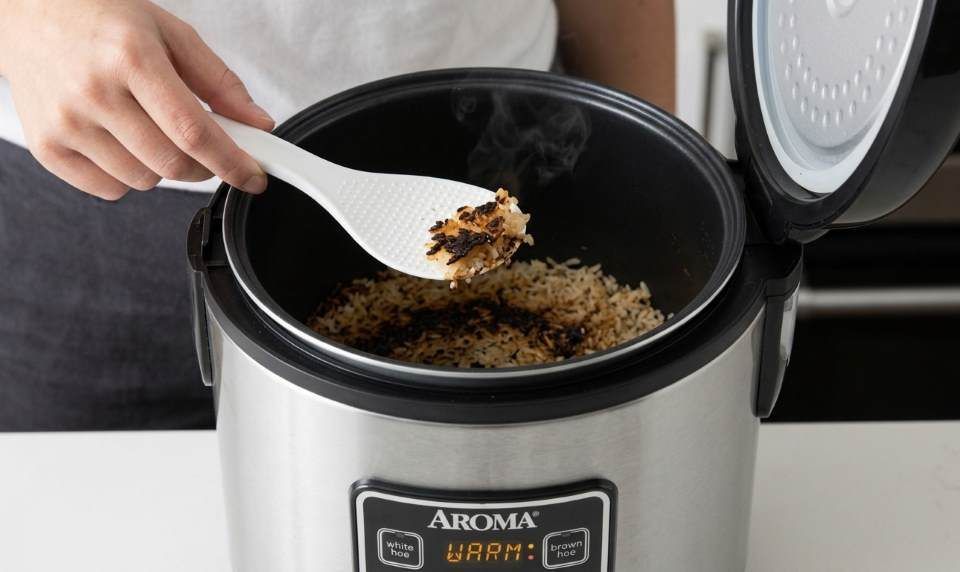 Aroma digital rice cooker with burned rice on bottom