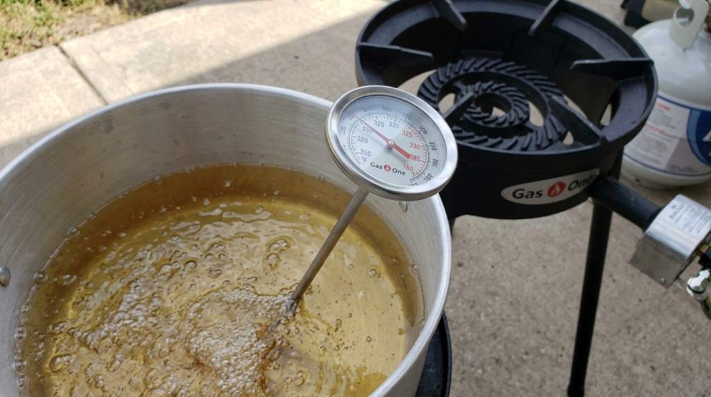 Propane fryer thermometer positioned correctly in cooking oil