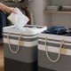 Homehacks laundry hampers organized beside a washing machine